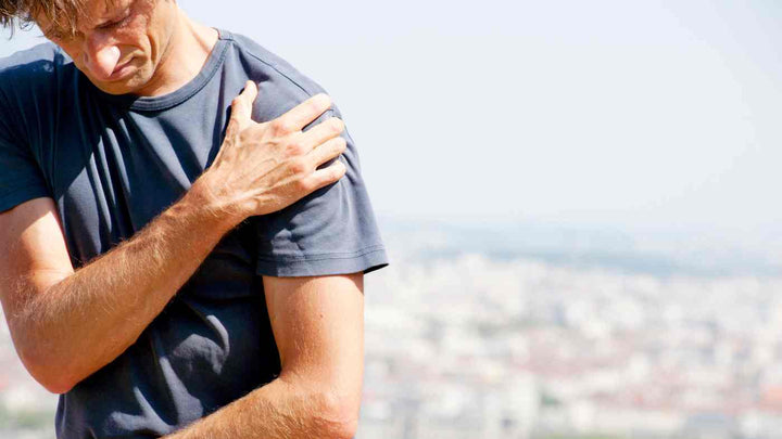 man holding shoulder in pain | Flents