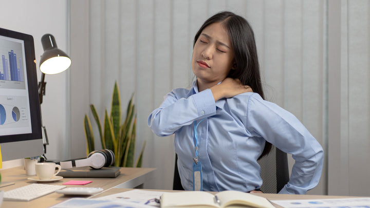 Image of woman in pain at desk | Flents