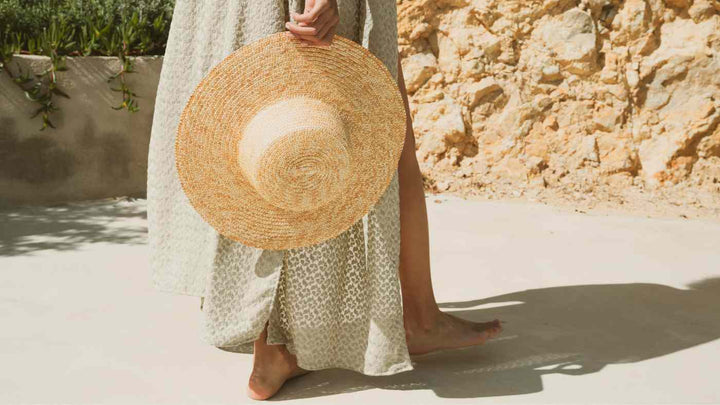 woman holding hat for Flents summer time blog