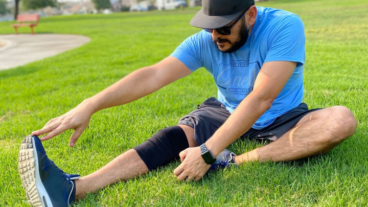 man stretching with strive wrap on calf
